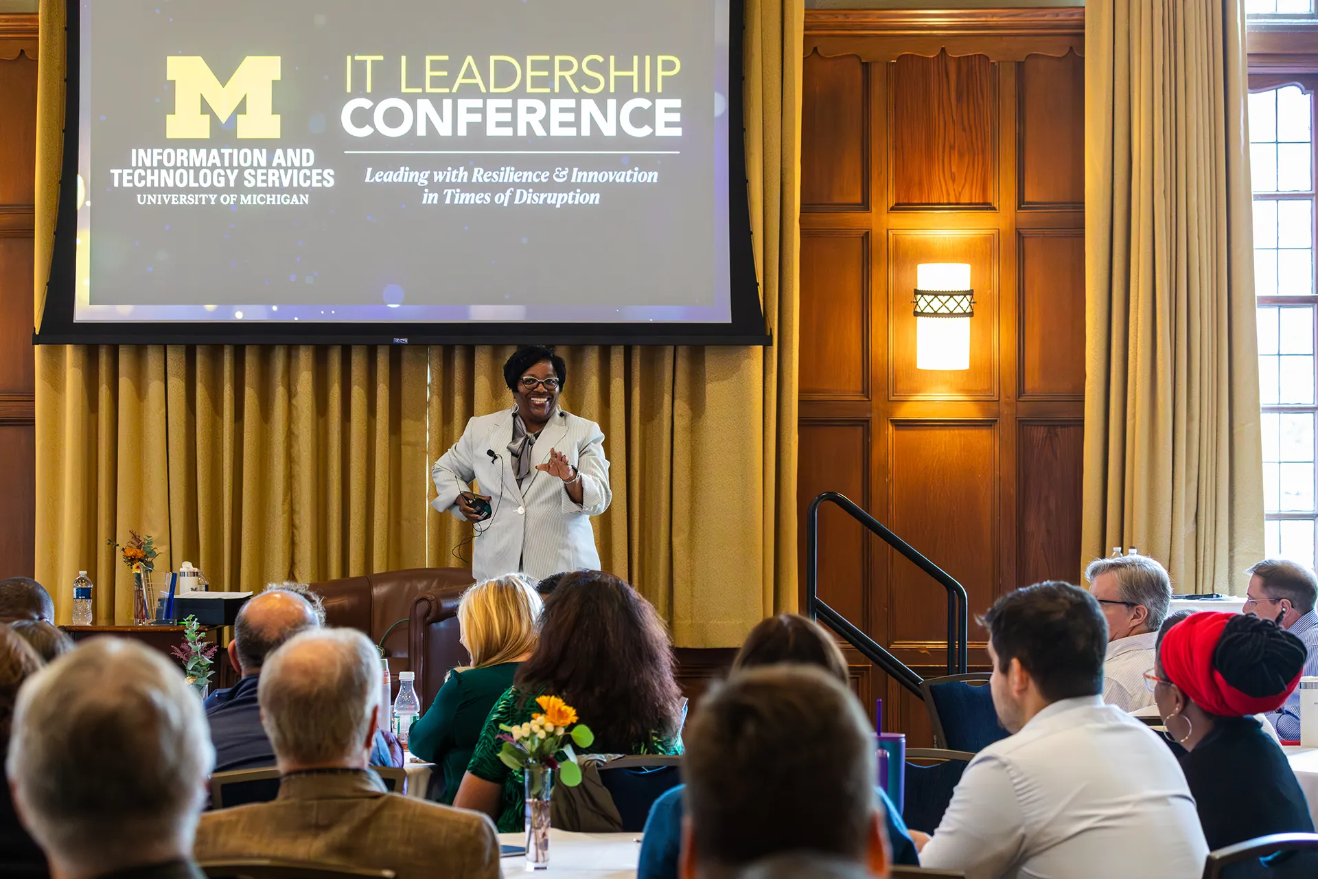 Diane Jones speaking on the dais in front of conference attendees